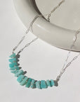 925 Sterling silver Apatite necklace laid on a white plate in the sunlight.