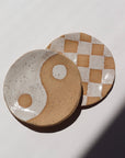 Ceramic Checkered jewelry dish laid against a white jewelry display. This is perfect to sit on your dresser and set your rings on.