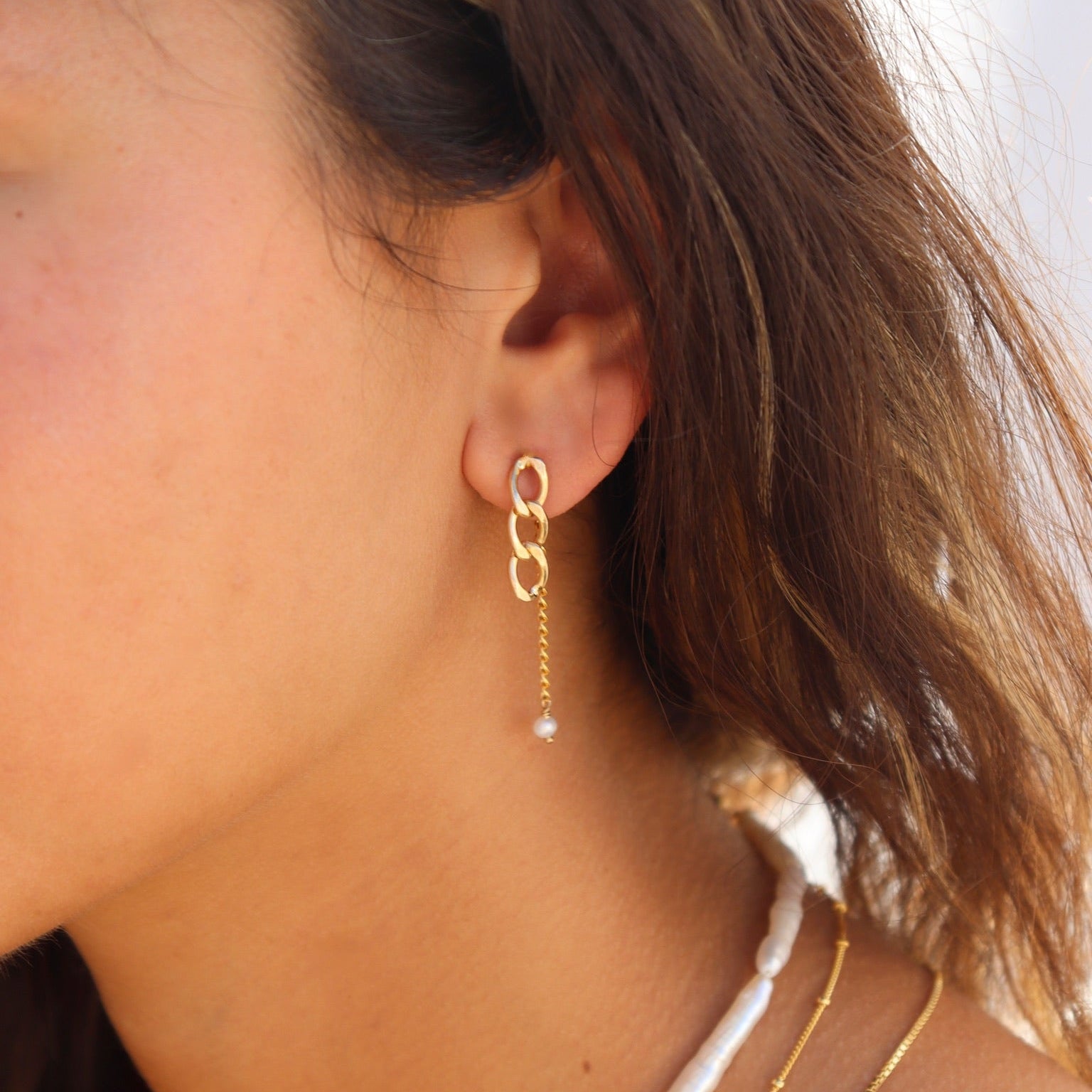 Model wearing 14k gold fill chain link drop earrings with a delicate chain and freshwater pearl accent, styled with layered gold necklaces and a freshwater pearl necklace.
