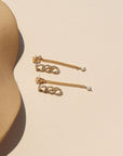 14k gold fill chain earrings with pearl accent on a light dish