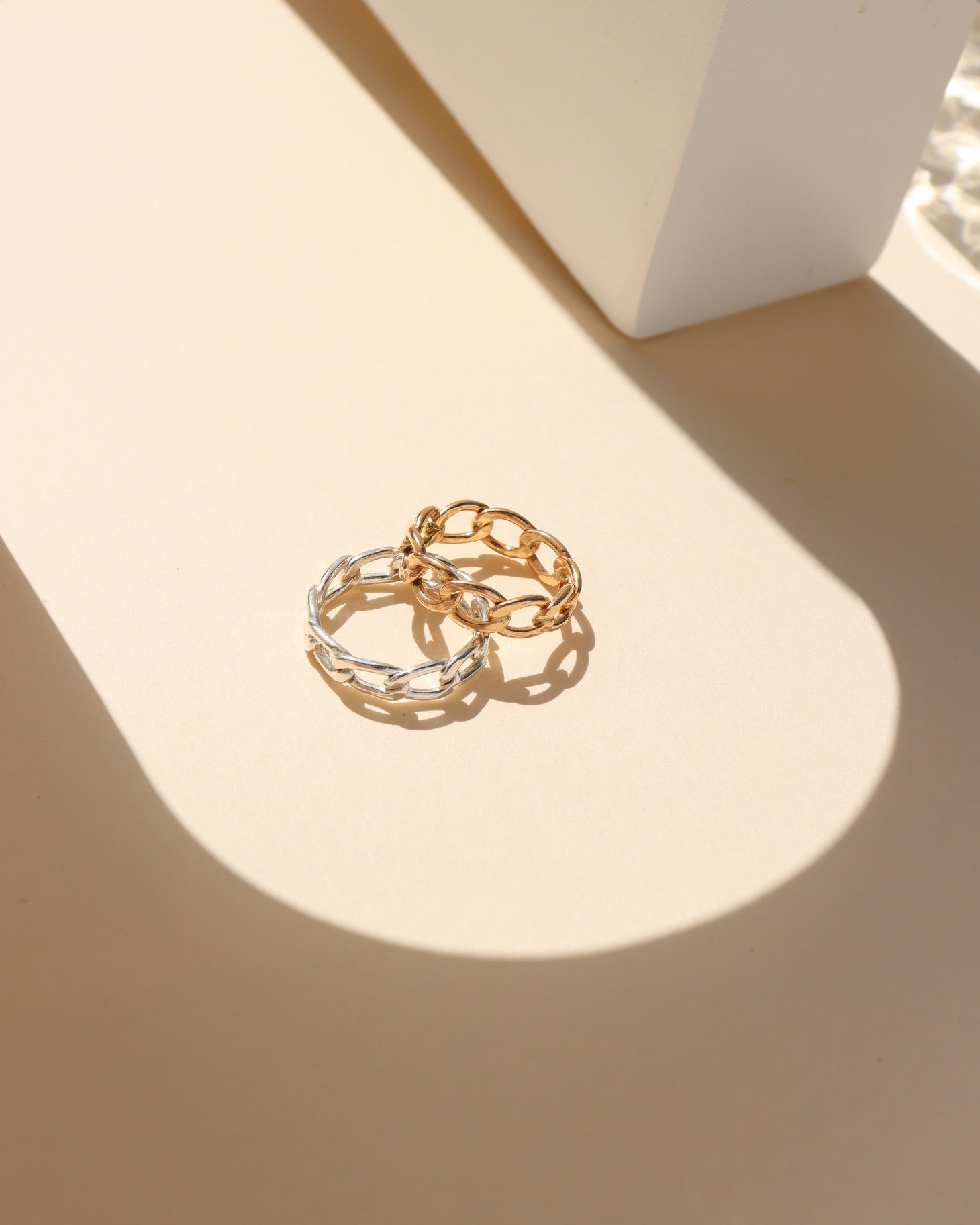 Alex Ring in gold fill and sterling silver, structural curb chain design, shown stacked with other rings and worn solo