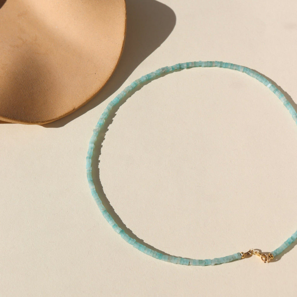 A fully beaded Amazonite necklace with a 14k gold fill standard clasp. The necklace is displayed on a cream back drop. 