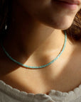 Model wearing a fully beaded Amazonite necklace with a 14k gold fill standard clasp. 