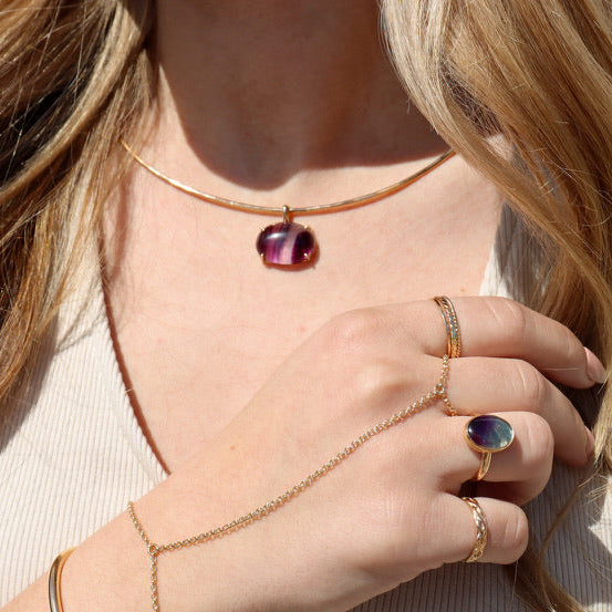 model wearing 14k gold fill wire collarbone necklace with handset fluorite stone in a bezel with other 14k gold fill jewelry