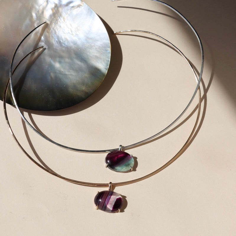 sterling silver and 14k gold fill wire collarbone necklace with handset fluorite stone in a bezel on a light dish