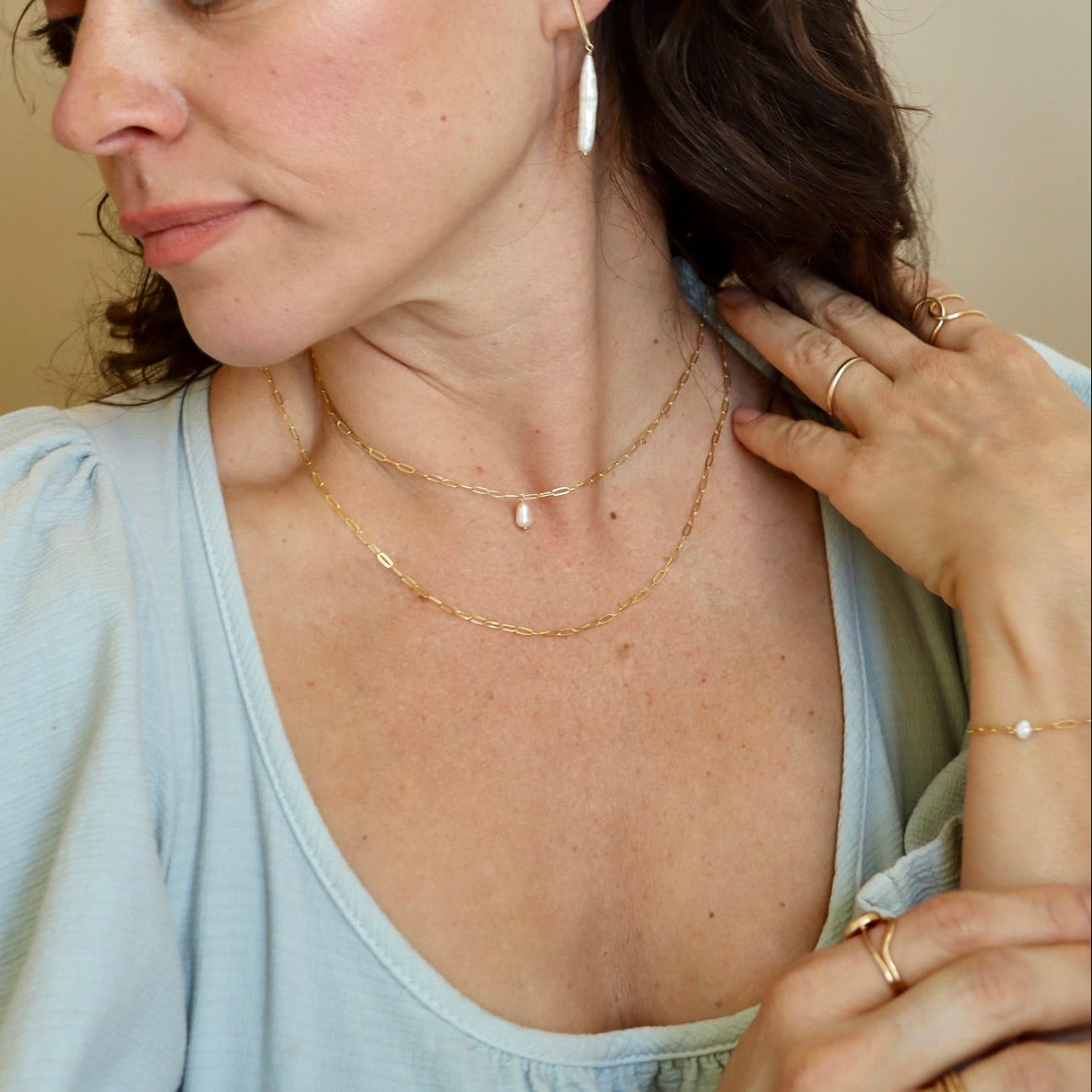 Ava Pearl Necklace with a minimalist sterling silver chain and elegant freshwater pearl centerpiece.