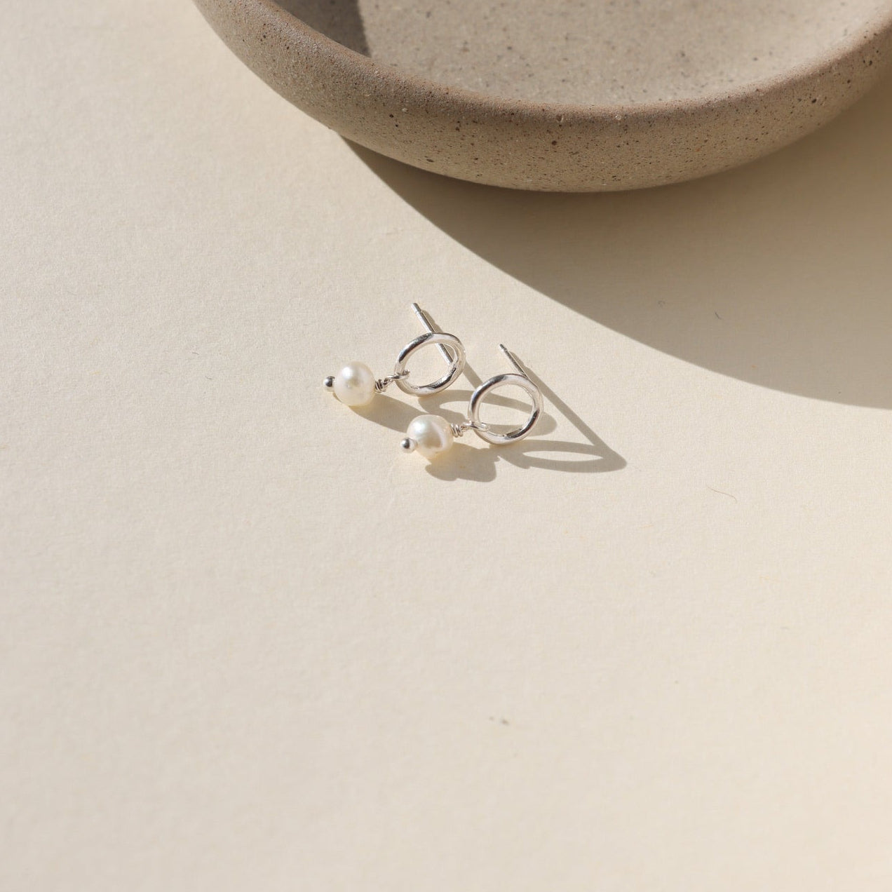 Ava Pearl Stud Earrings with minimalist sterling silver settings and elegant freshwater pearls.