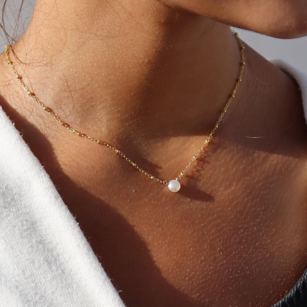 14k gold fill Beaded pearl necklace photographed on a model wearing a white sweater