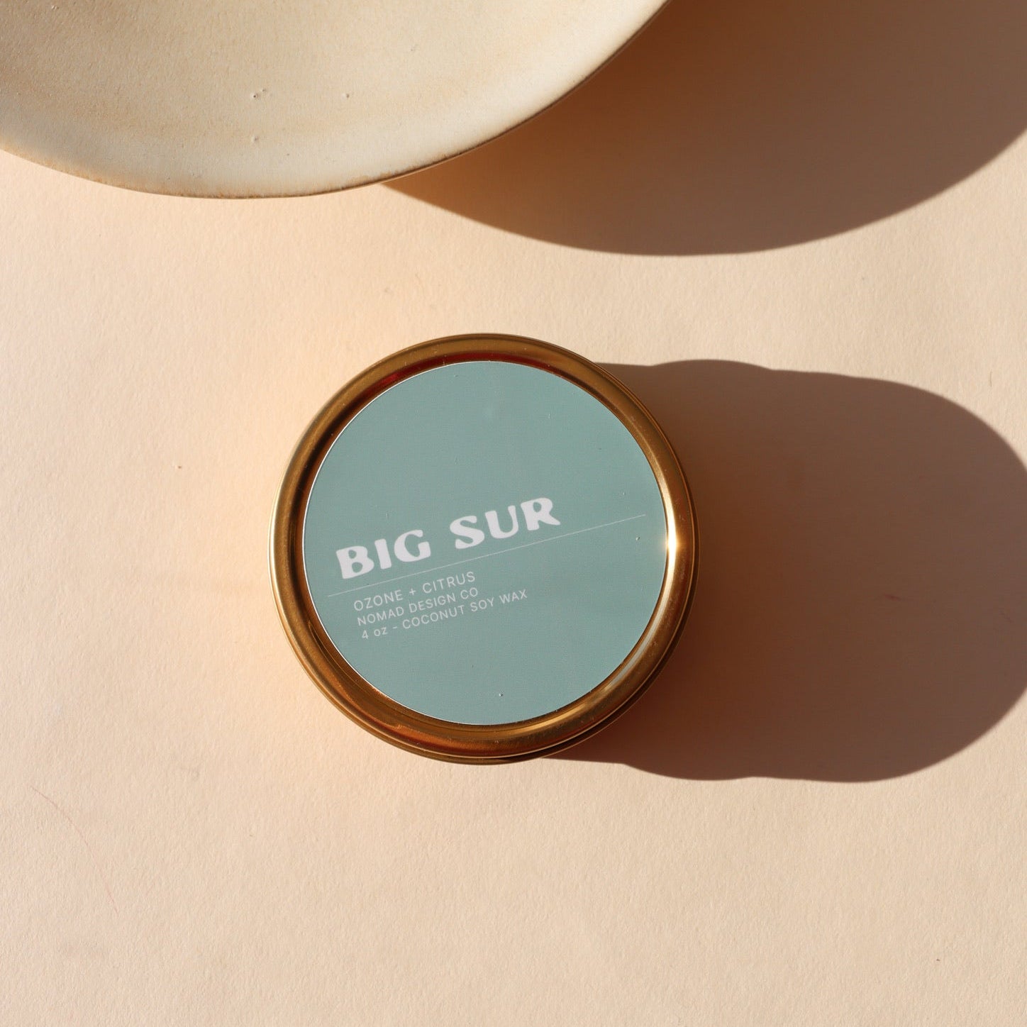 blue candle tin in the scent Big Sur in the sunlight