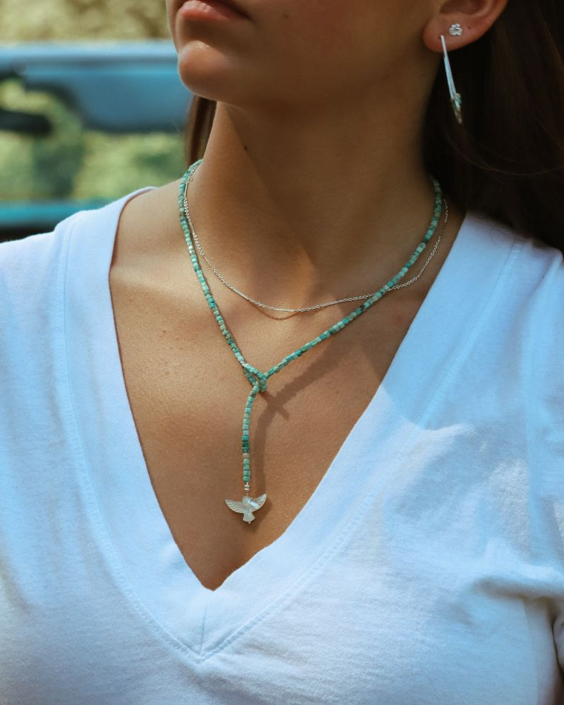 model wearing sterling silver chain necklace with turquoise beaded necklace