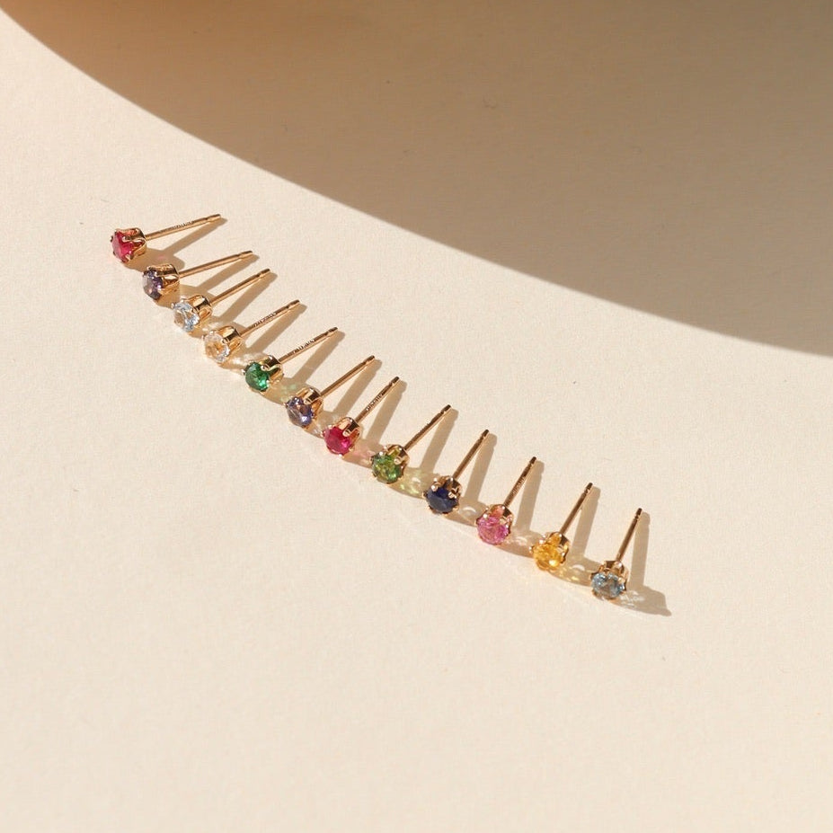 group photo of 14k gold fill birthstone prong stud earrings featuring 3mm gemstones on a light surface