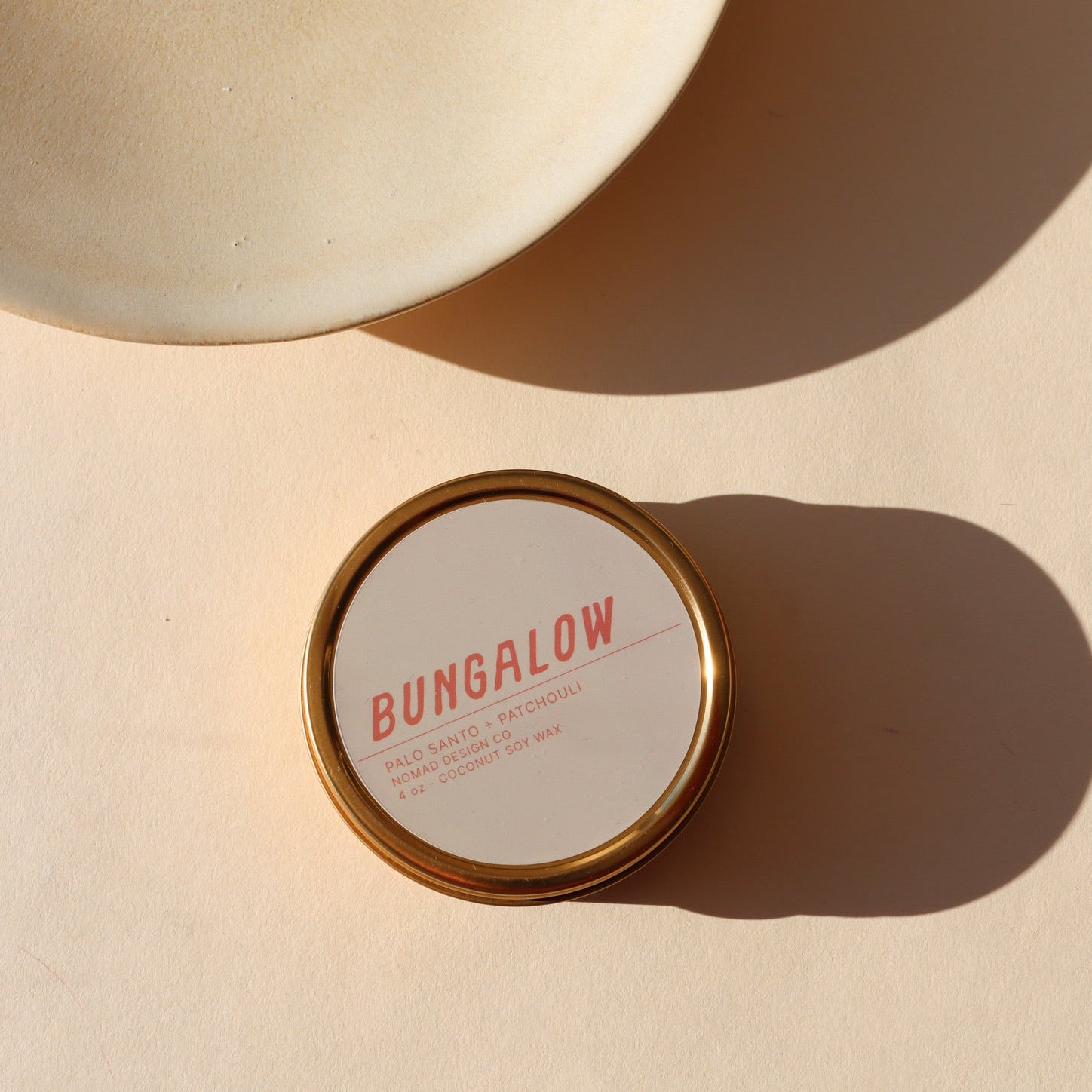 gray candle tin in the sunlight - scent Bungalow