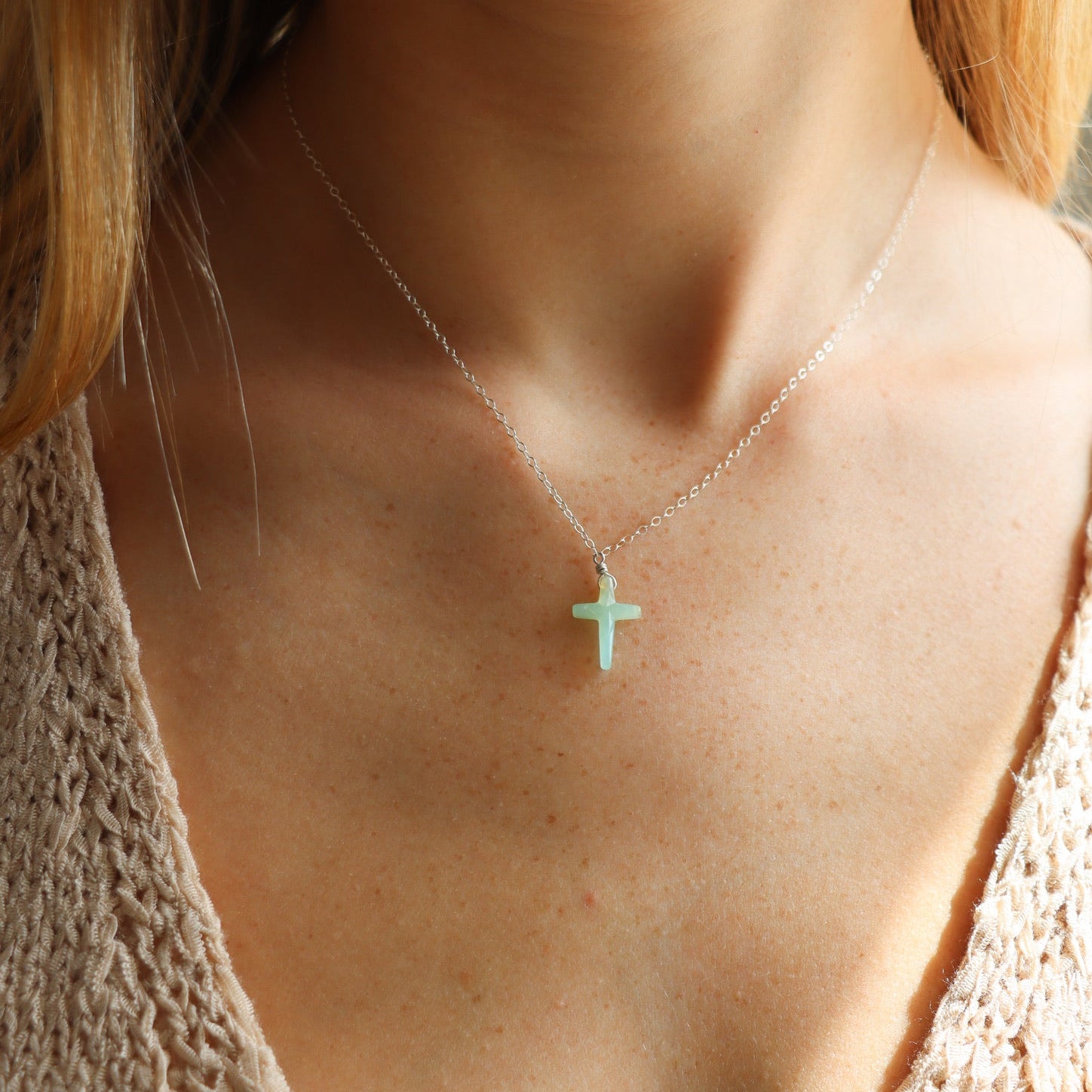 model wearing sterling silver delicate chain necklace with Chrysoprase Cross charm