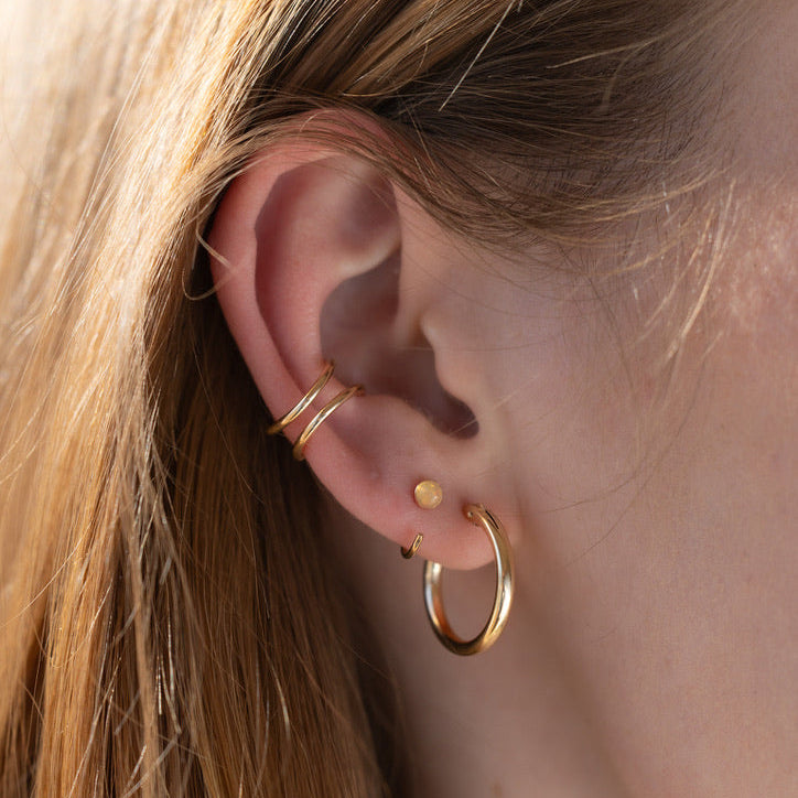 model wearing 14k gold fill ear cuff with hoops and huggies