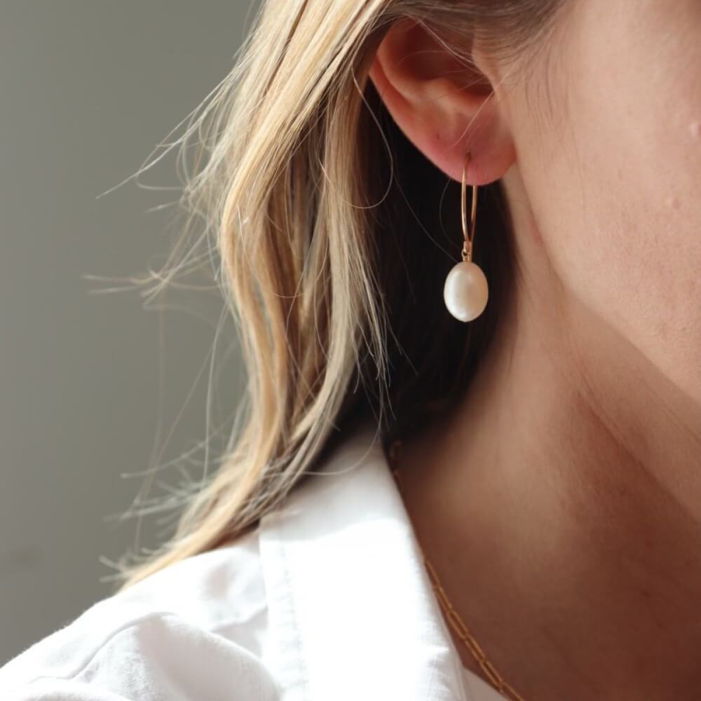 model wearing handmade 14k gold fill wire earrings with freshwater pearls
