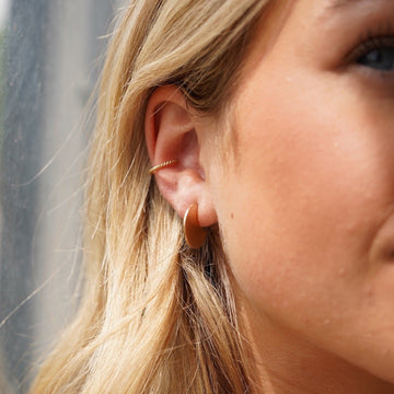 Model Wearing 14k gold fill Mini Echo Studs paired with a spiral ear cuff.