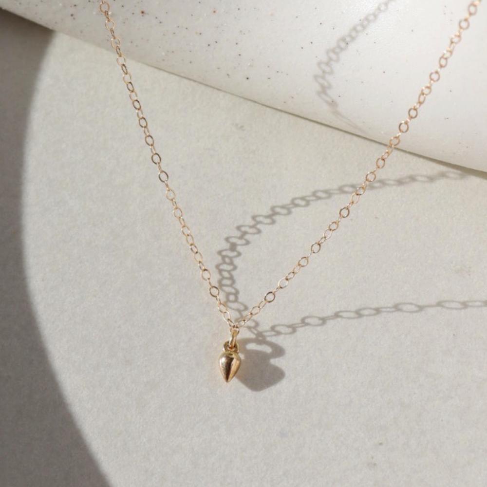 solid gold pear shaped drop necklace, gold charm necklace, token jewelry, solid gold token necklace, solid gold necklace, gold charm necklace, made in Eau Claire, handmade jewelry, made in the USA, woman owned business, vegan leather box