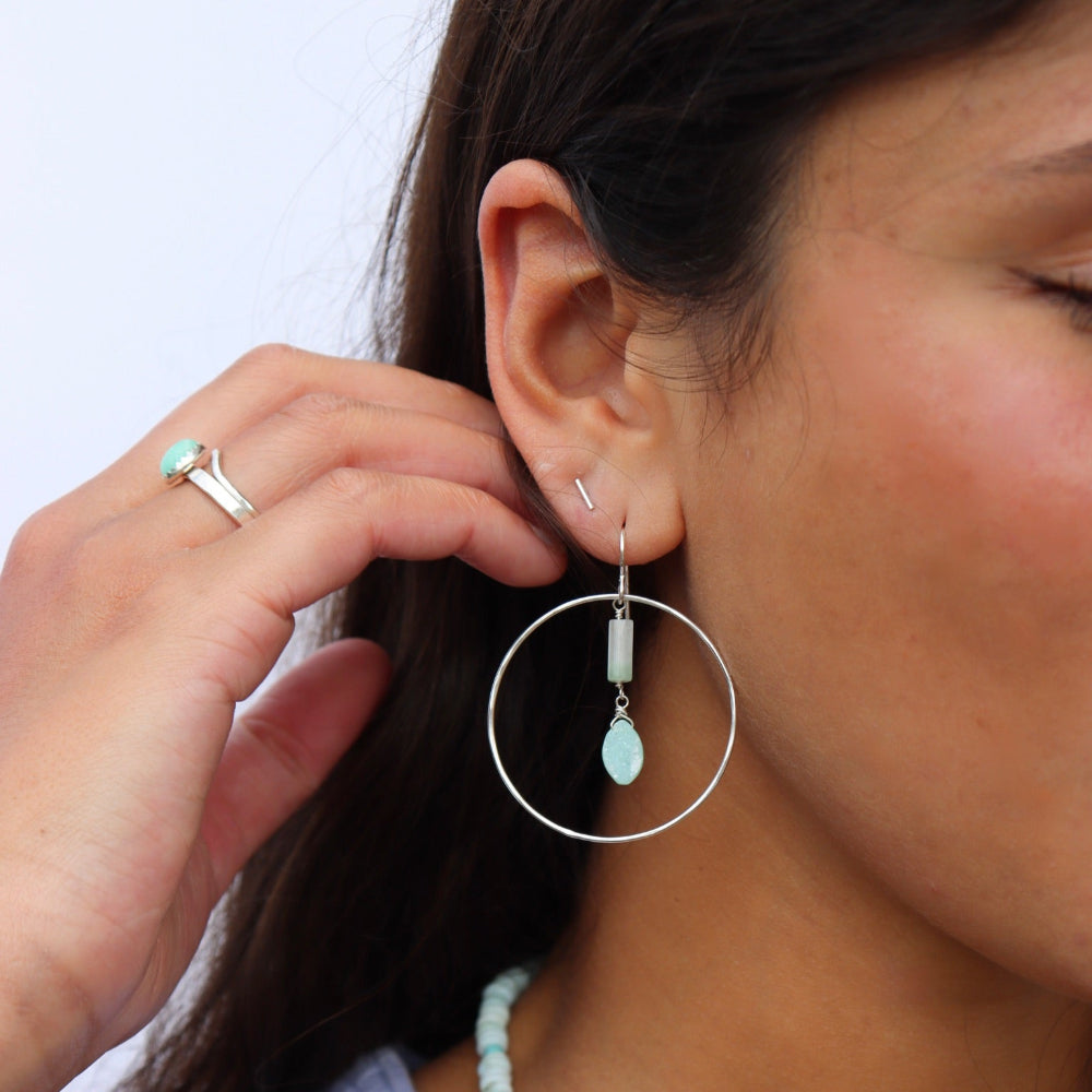 Model wearing a sterling silver hoop with druzy + burma jade gemstones dropping from the ear post. 