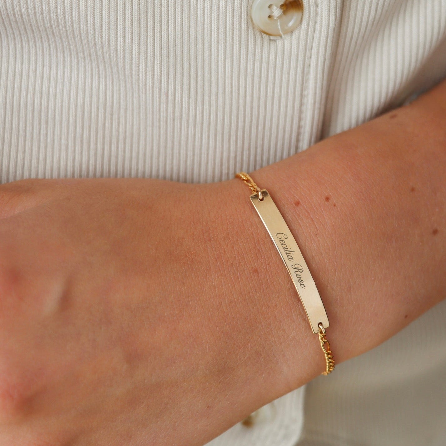 model wearing 14k gold fill chain and bar bracelet with custom engraved bar