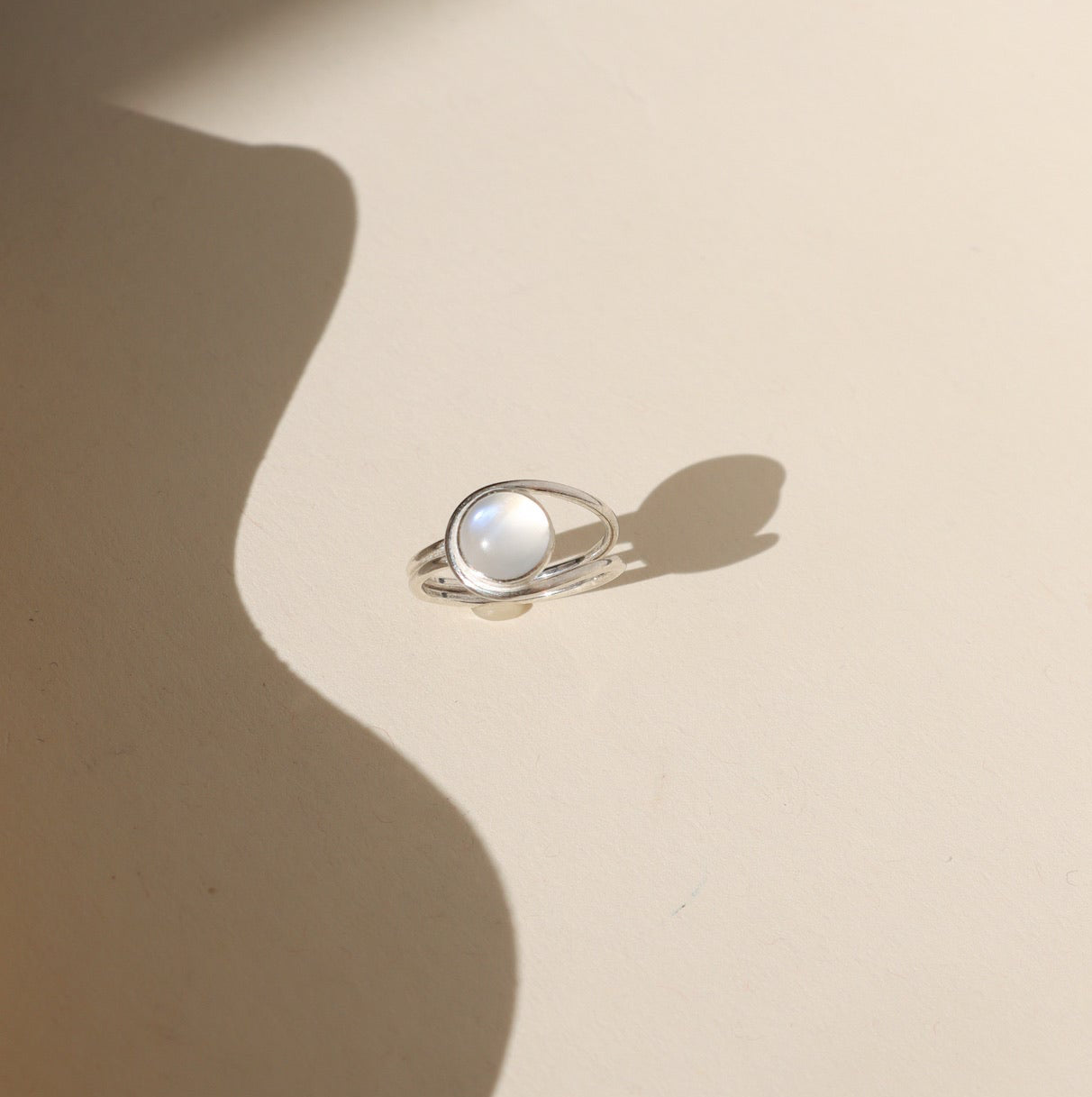 sterling silver esme ring - moonstone - laid in sunlight