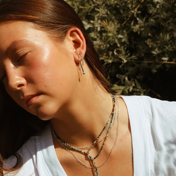 model wearing sterling silver chain necklaces with beaded wrapped necklace