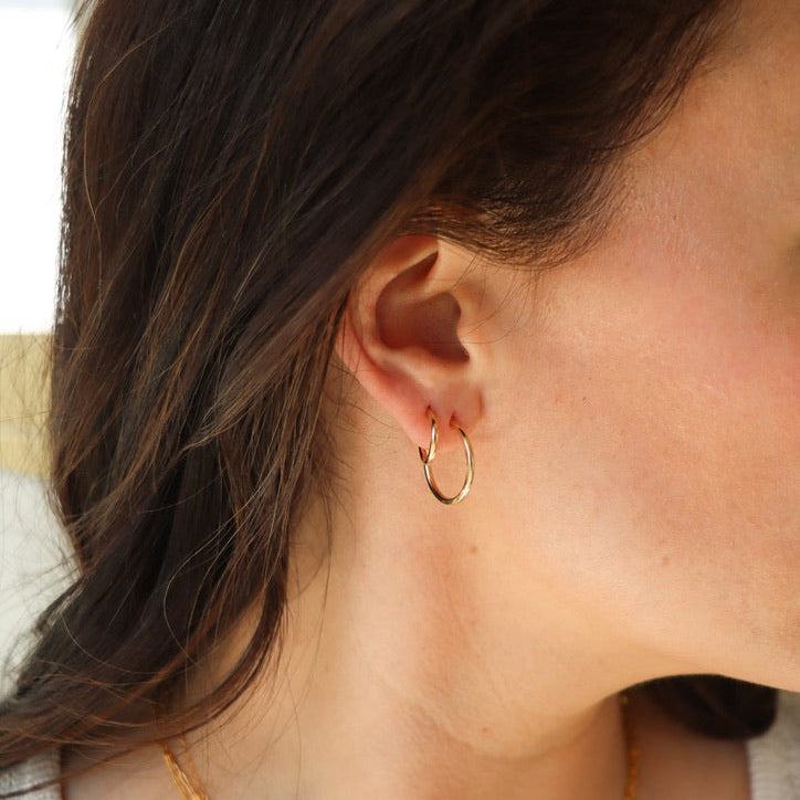 model wearing 14k gold fill hammered hoops