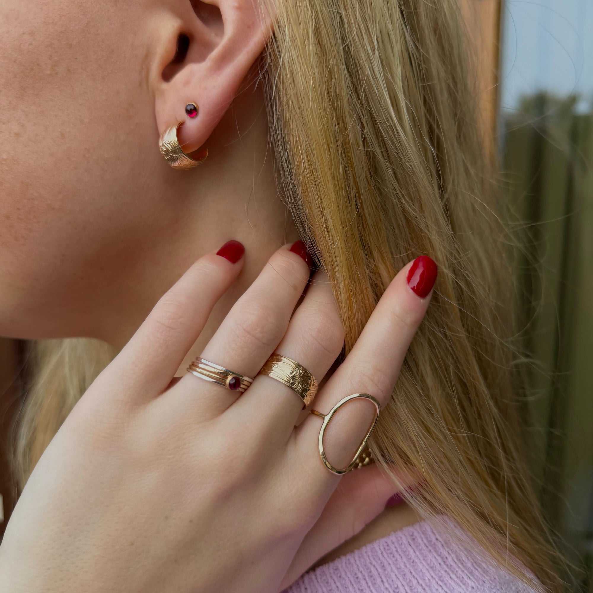 Close-up of Florence gold fill huggie  styled on model 