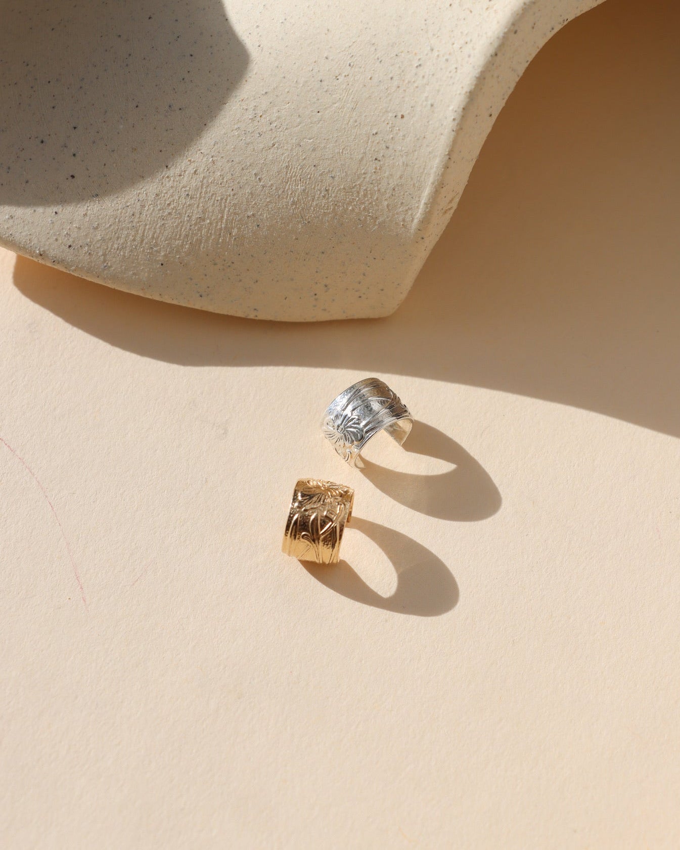 14k gold fill and sterling silver textured ear cuffs in the sunlight