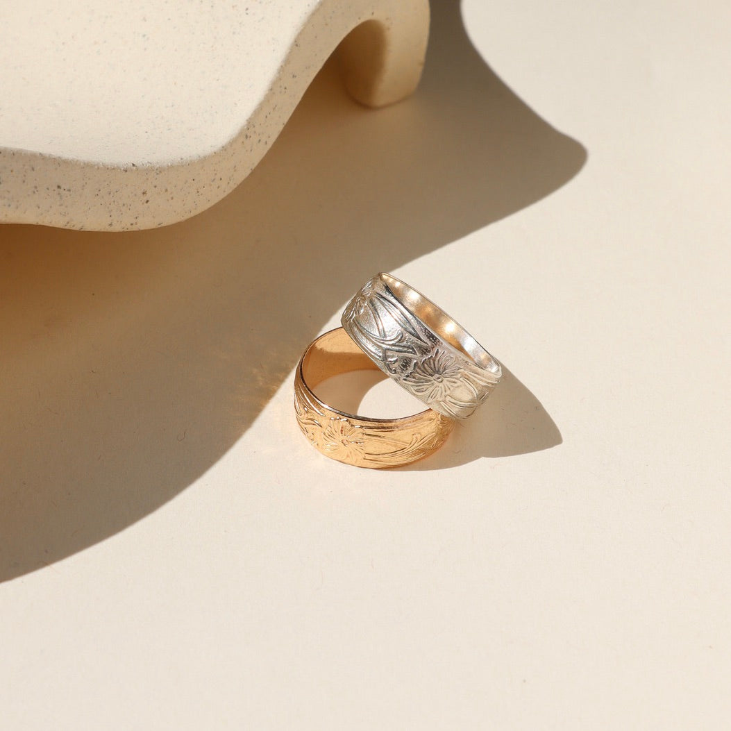 14k gold fill and sterling silver textured band rings on a light surface