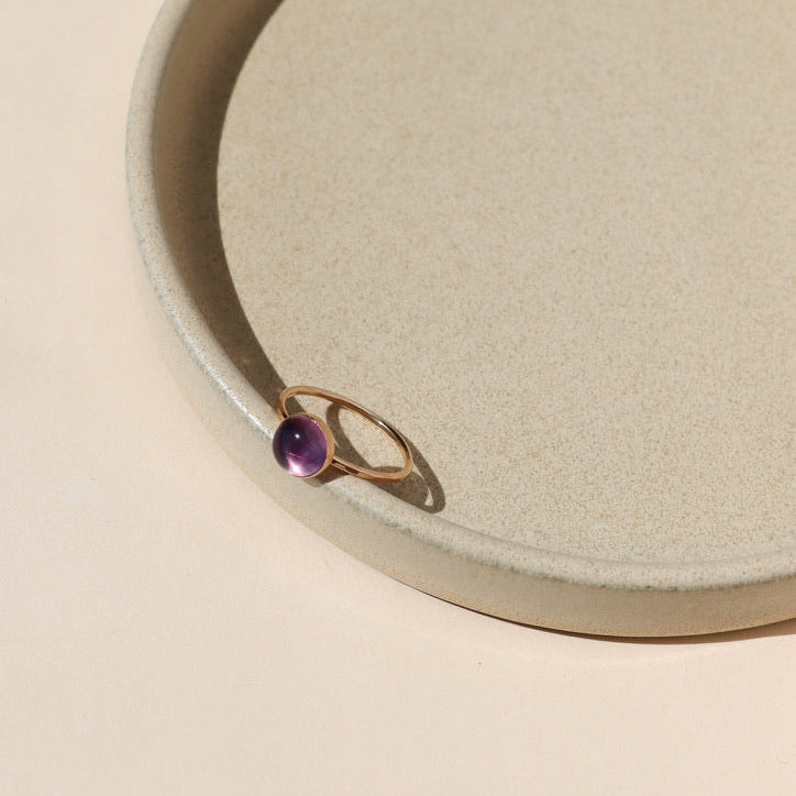 14k gold fill ring setting with round fluorite stone on a light background
