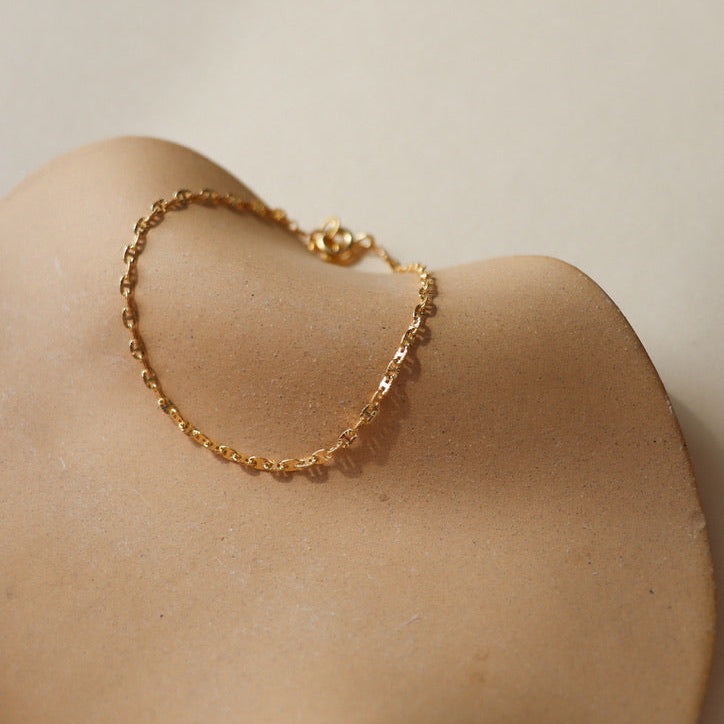 14k gold fill chain bracelet on a light dish