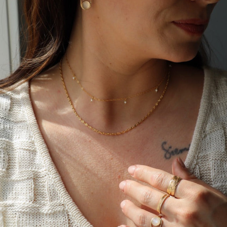 model wearing 14k gold fill sparkly chain with 14k gold fill delicate chain necklace with pearls paired with 14k gold fill rings