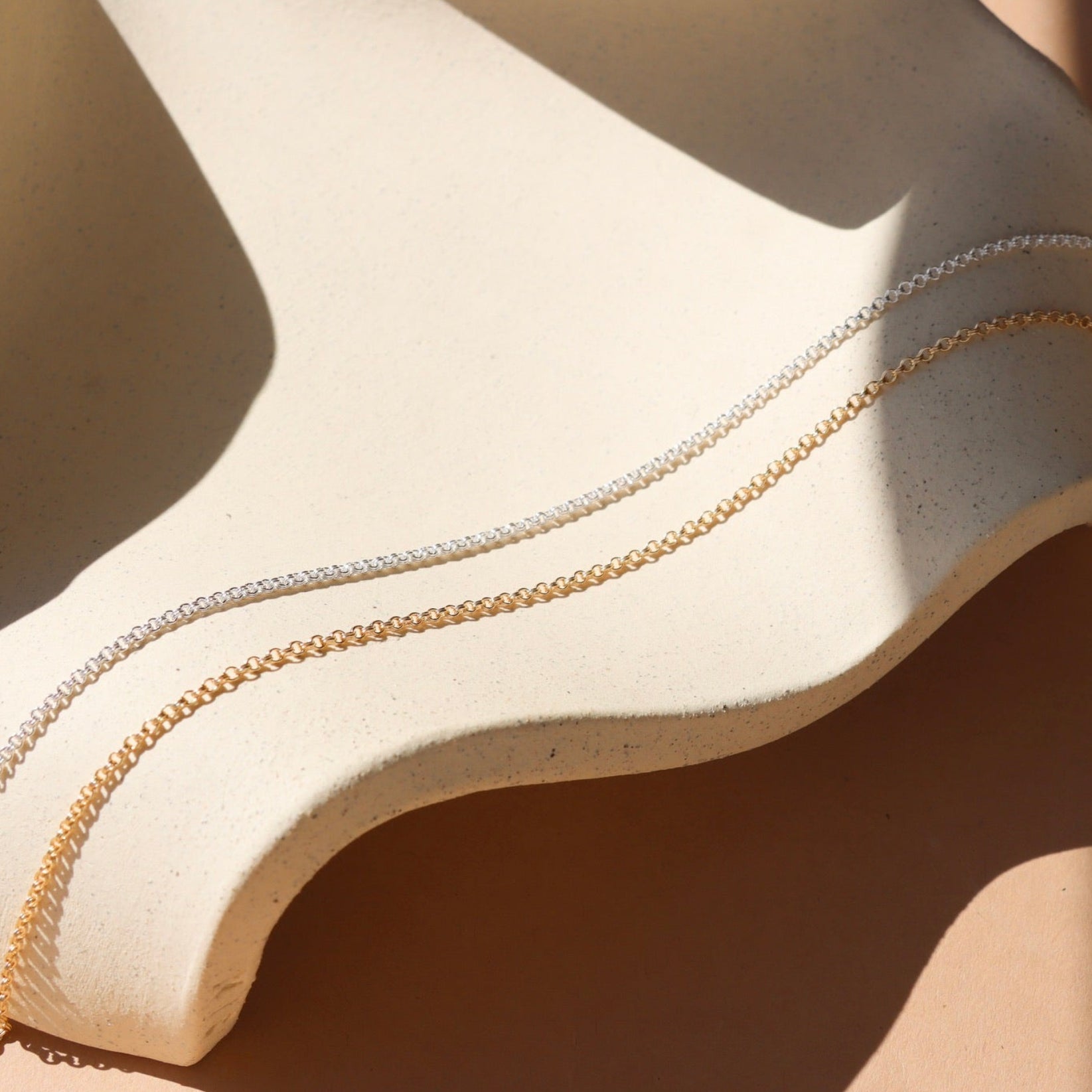 sterling silver and 14k gold fill chains in the sunlight