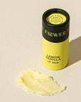 Lemon Vanilla lip balm with a visible brand name on a beige background
