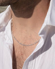 Model wearing 925 sterling silver Gio chain laid in the sunlight.
