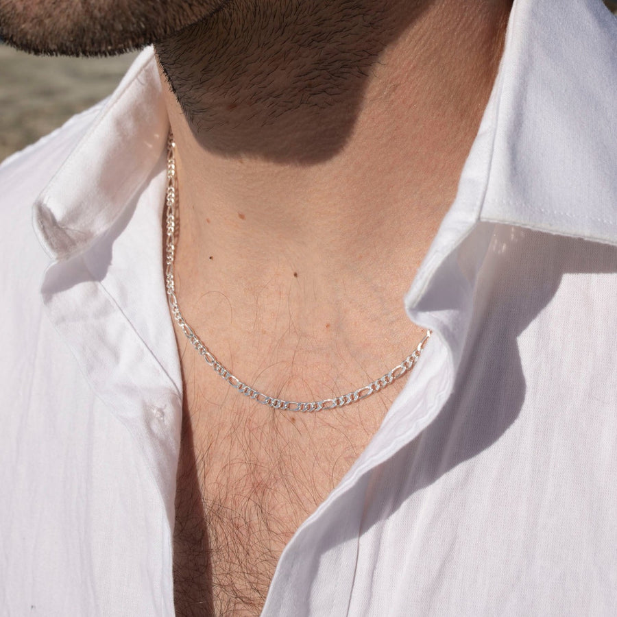 Model wearing 925 sterling silver Gio chain laid in the sunlight.