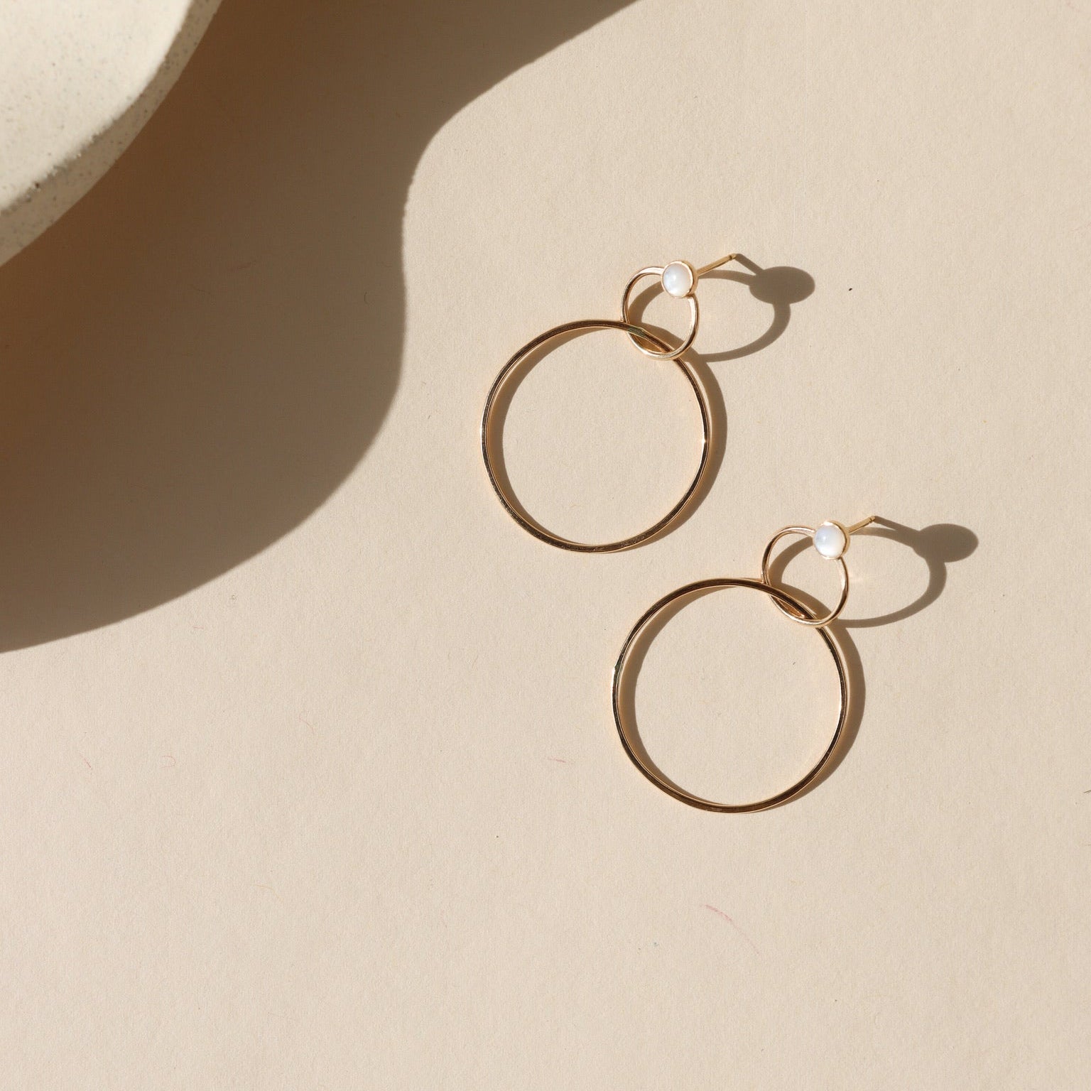 14k Gold fill stud earrings with handmade circle drops on a light background