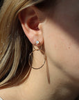 model wearing 14k gold fill pearl stud earrings with circular drops dangling down