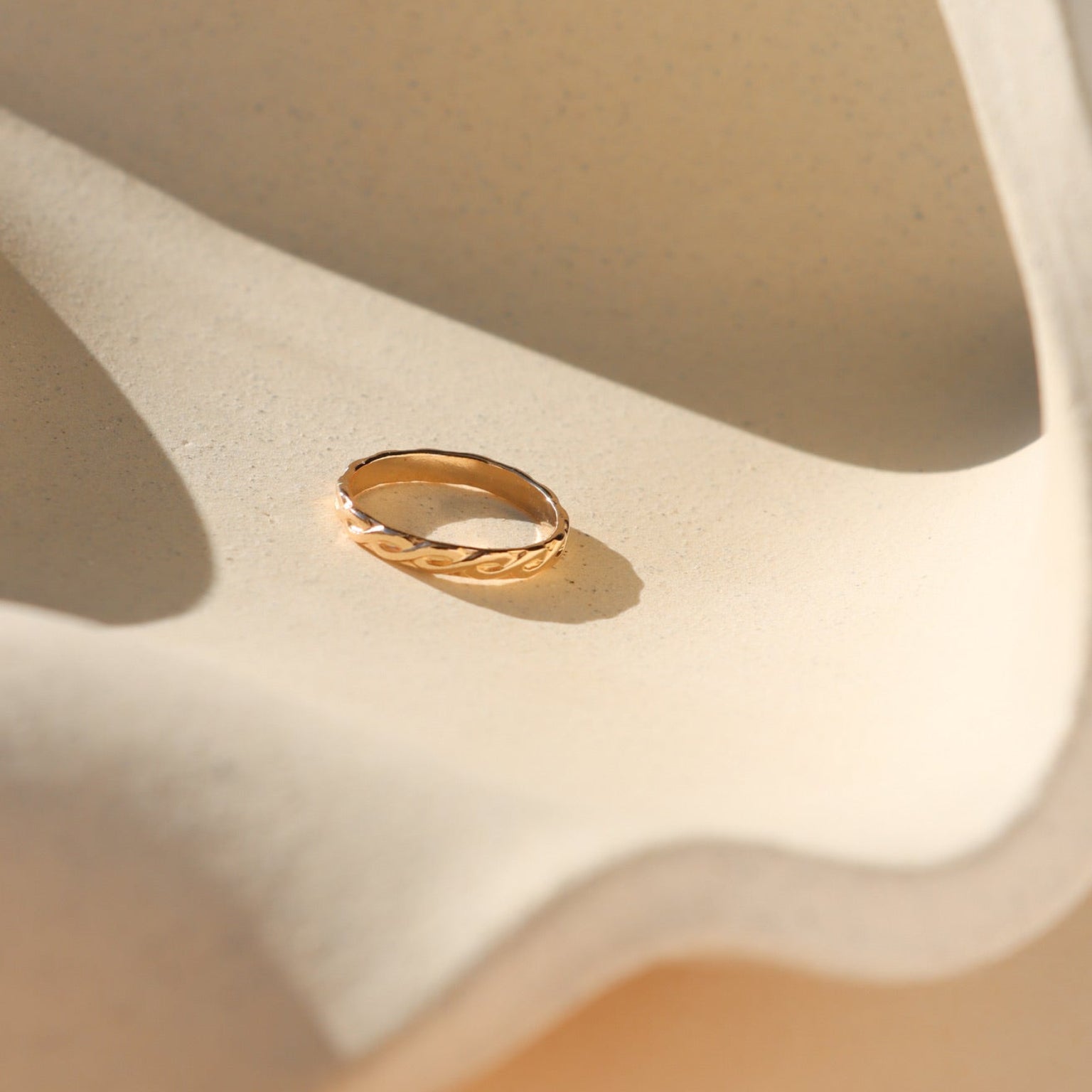14k gold fill textured ring on a light dish