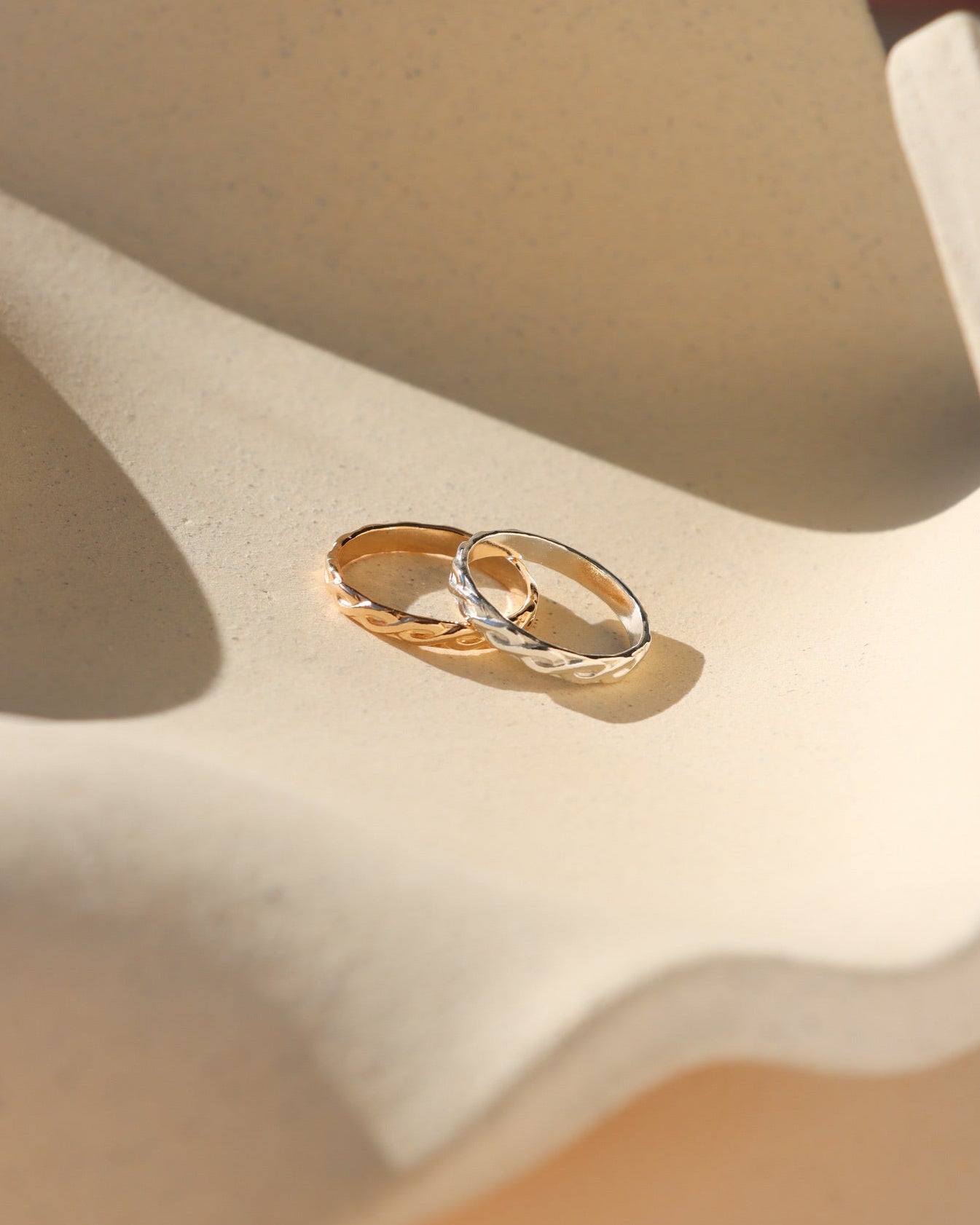 14k gold fill and sterling silver textured ring on a light dish