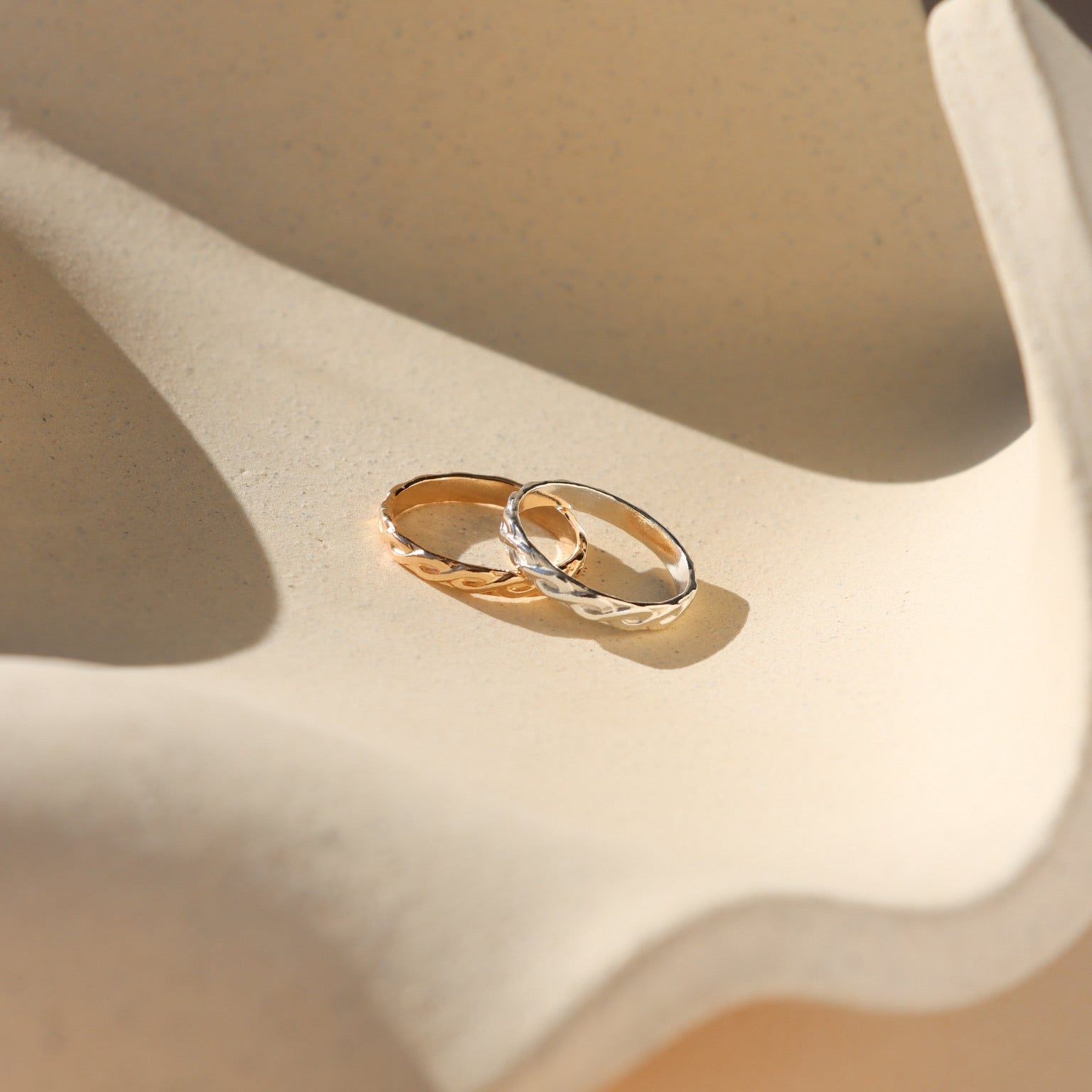 14k gold fill and sterling silver textured ring on a light dish