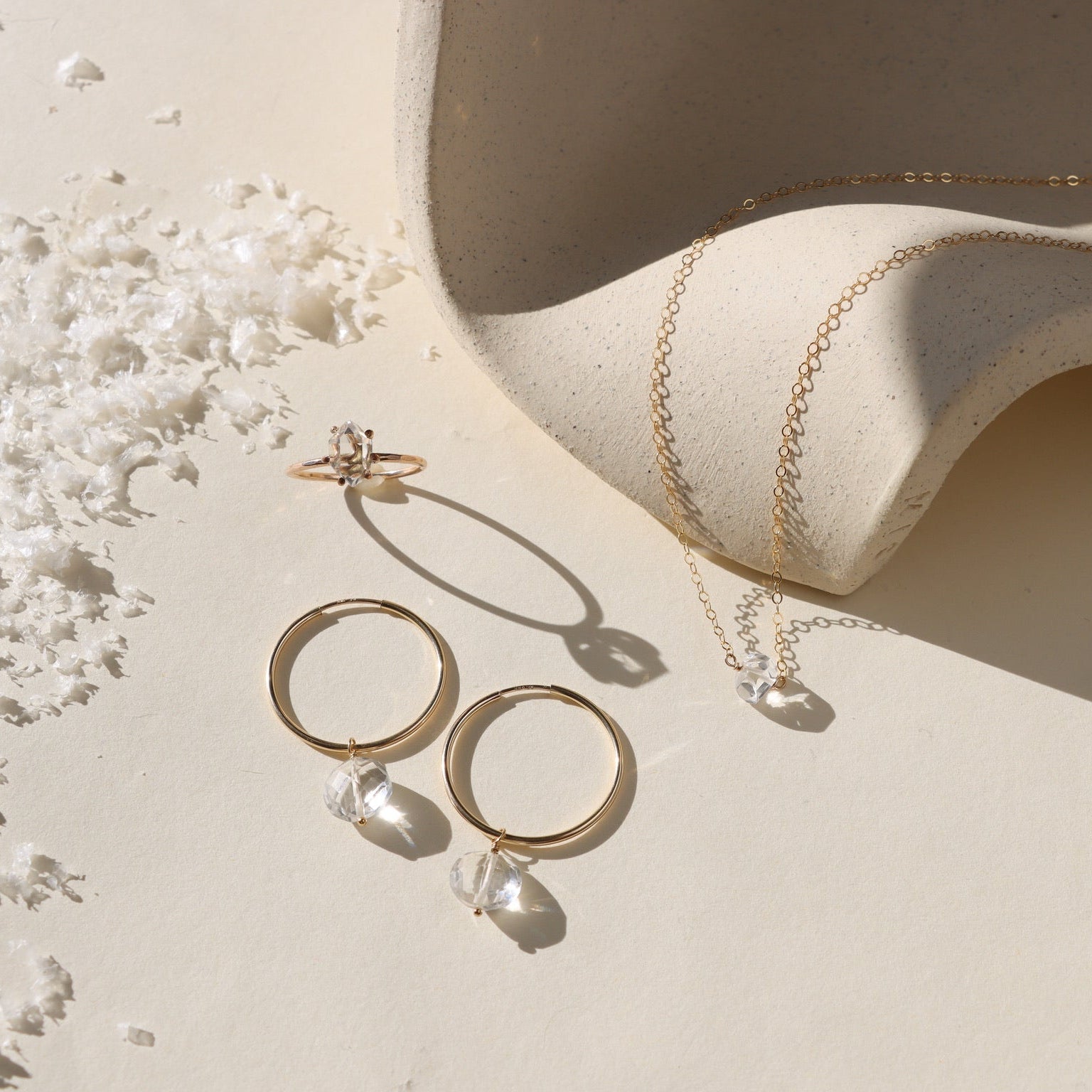 Handcrafted gold hoops adorned with faceted crystals for a subtle shimmer and timeless look.