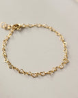 14k gold fill linked heart chain bracelet on a sunny backdrop