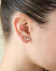 small gold fill arrow and heart stud earrings set, photographed on a model