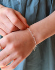 925 sterling silver heart link chain in children's sizes, photographed on a young girl's wrist