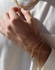 Model wearing 14k gold fill Alex Bracelet paired with the la mer bracelet.