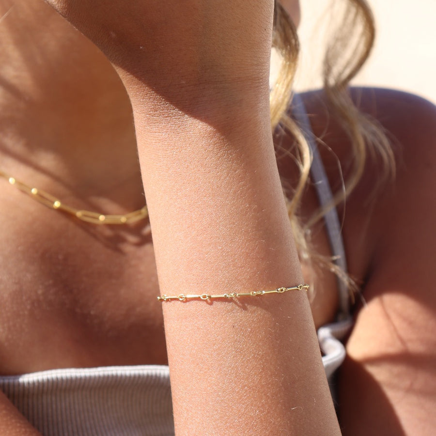 Model wearing 14k gold fill dot + dash bracelet