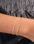 Model wearing 14k gold fill Gigi bracelet paired with the sailor bracelet