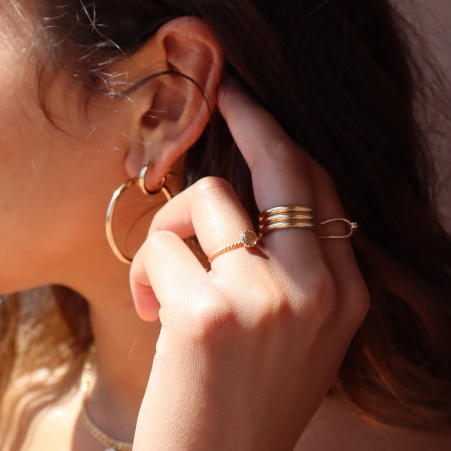 Model Wearing 14k gold fill Gaia Ring. This ring features a Spiral band with a zircon gemstone.