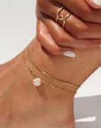 Model wearing a 14k gold fill Delaney anklet